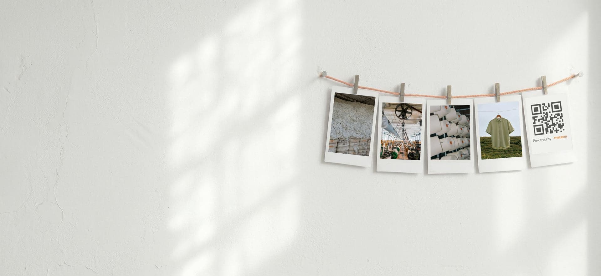 Polaroid photos of raw materials and a QR-tagged garment pegged to a line